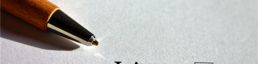 A pen with a piece of paper with a box next to 